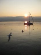 sailboat on the lake at a quiet sunset