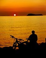 distant view of an orange sunset over the sea