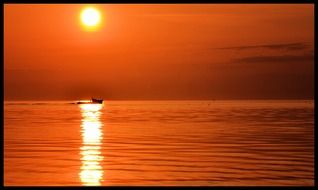 distant view of the boat at sunset