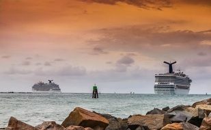 two cruise liners near the rocky shore