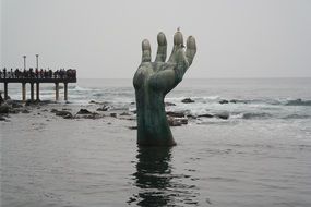 statue hand in water