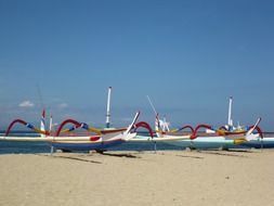 boats on a tropical beach on a sunny day, indonesia, bali, sanur