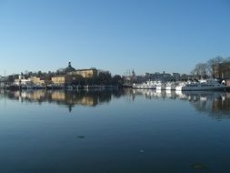 the river reflects houses in the water