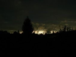 light on the horizon behind dark clouds
