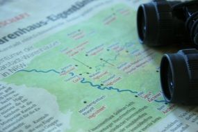 binoculars on map, travel, still life