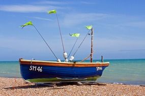 blue fishing boat on the beach