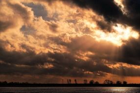 romantic sunset in the clouds above the water