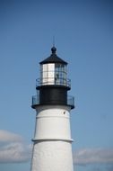 a large lighthouse with a black room on it