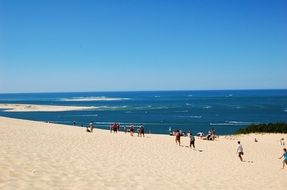 dune beach with colorful people scene