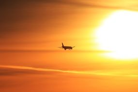 romantic sunset silhouette of airplane travel plane