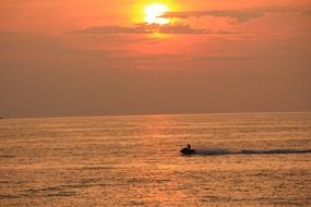 boat at sea during sunset