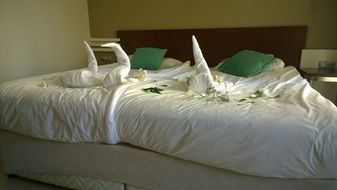 double bed decorated white swams