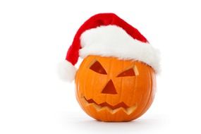 carved pumpkin in Santa hat