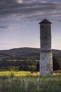 high stone tower at the countryside in France