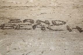 inscription on a sandy beach