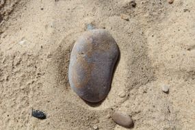 smooth big stone in the sand