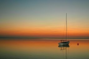 lonely yacht in the sea the quiet beauty of the sunset