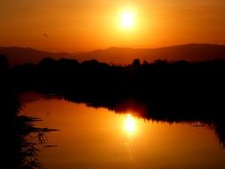 Sunset against the backdrop of a scenic landscape