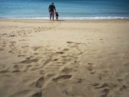 man and boy on seashore