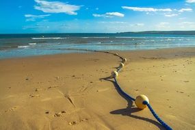 Blue rope with yellow buoys on the beach in Poole