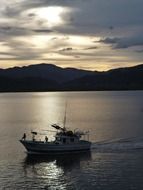 panorama of a fishing boat at dusk