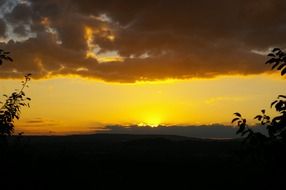 yellow clouds and bright sun on the horizon