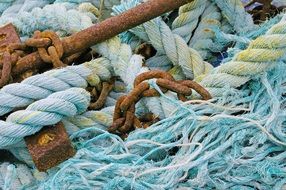 Blue ropes and rusty anchor on a fishing boat