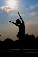 girl silhouette against blue sky