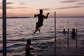 diving from a pier on vacation