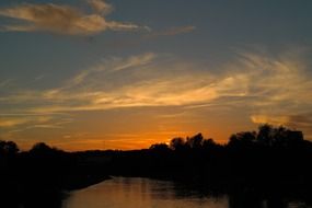 orange romantic sunset in the evening sky, river danube