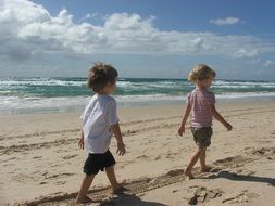children walk on the sand