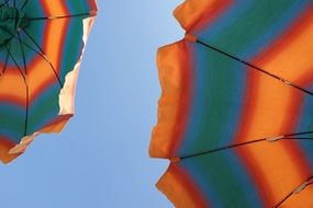 colored parasols against the blue sky