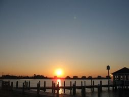 waterfront of distant city at sunset