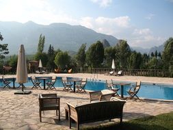 tables with chairs by the hotel pool in Kemer, Turkey