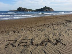 inscription relax on the sand by the sea