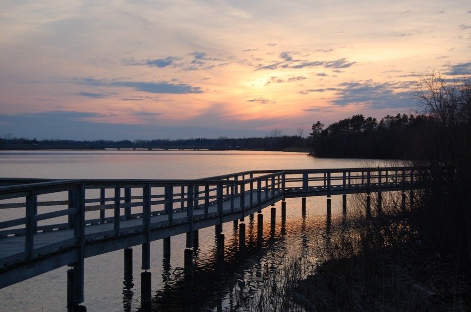long boardwalk over the lake at dusk