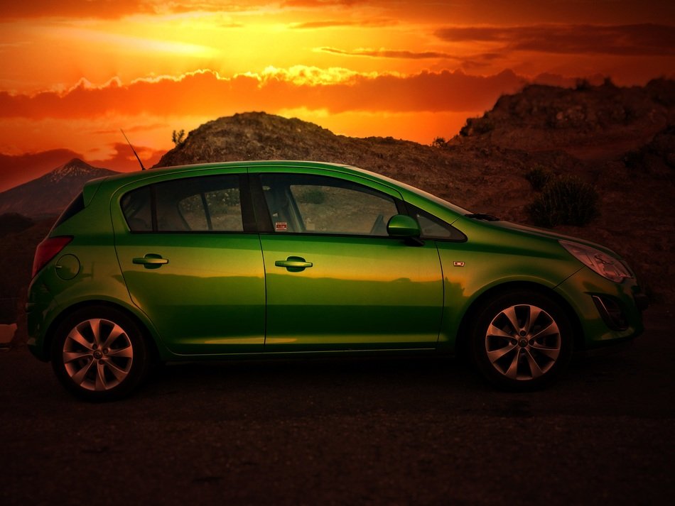 green opel on sunset background
