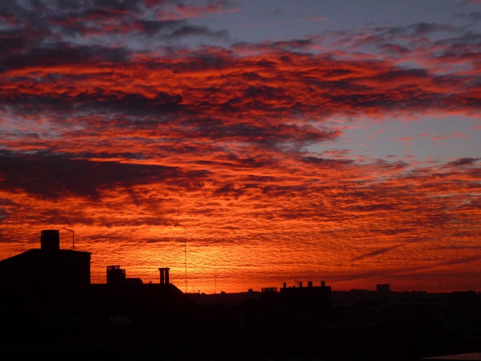 orange sunset in the clouds over madrid