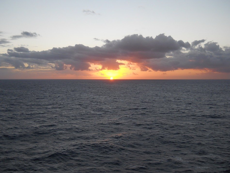 bright sunset and dark clouds on the horizon