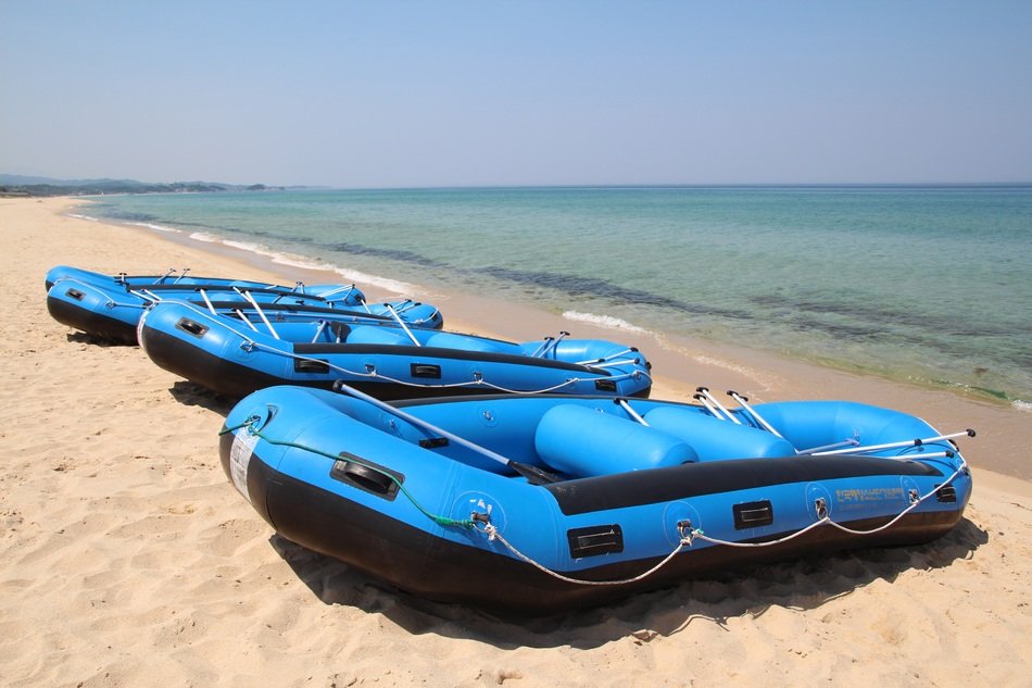 Black and blue rubber boats on beach