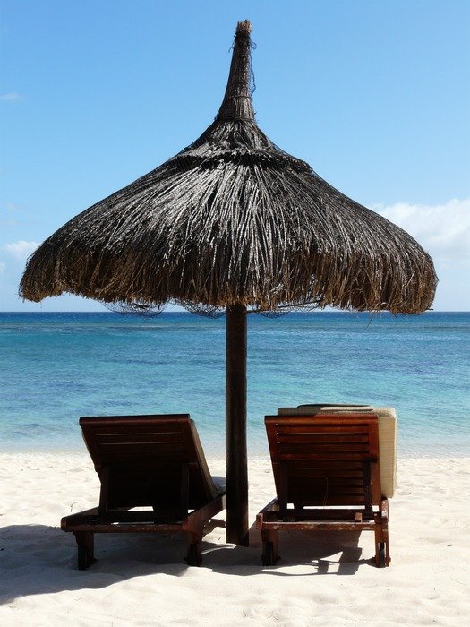 canopy over sun loungers on the sandy beach with beautiful water