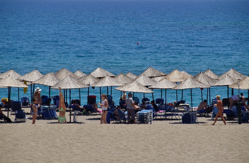 people under umbrellas on the beach