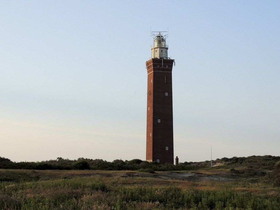 old lighthouse at evening sky, north sea coast
