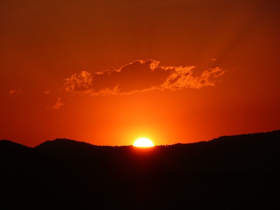 sunset afterglow above dark landscape