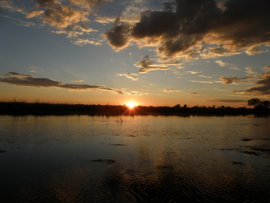 distant sunset over the Okavango Delta