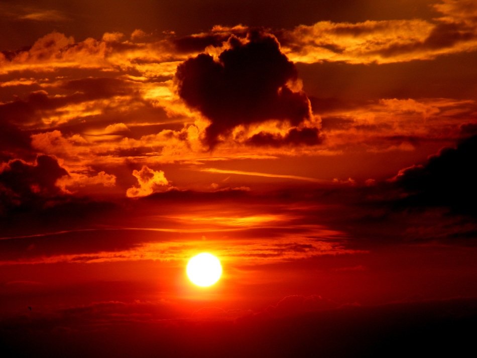 Sun at sunset amid the clouds