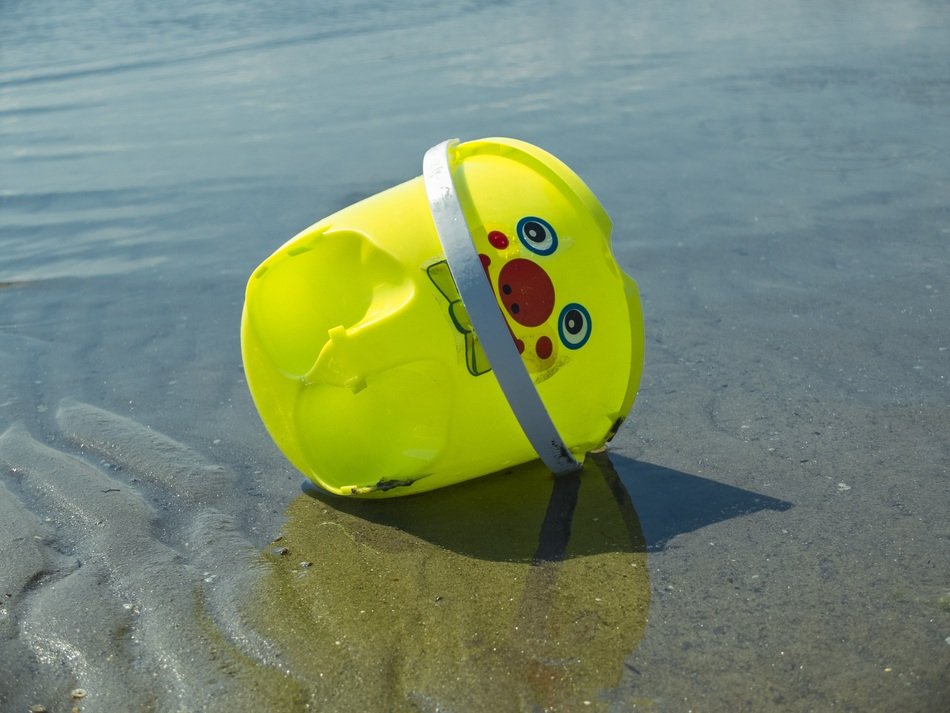 yellow bucket as a beach toy
