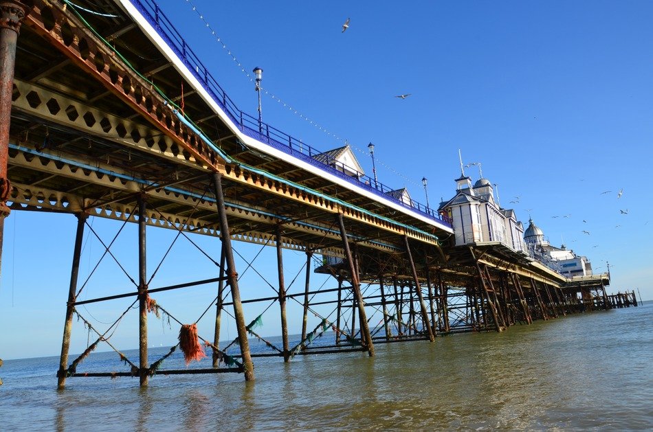 victorian buildings on pier above sea, uk