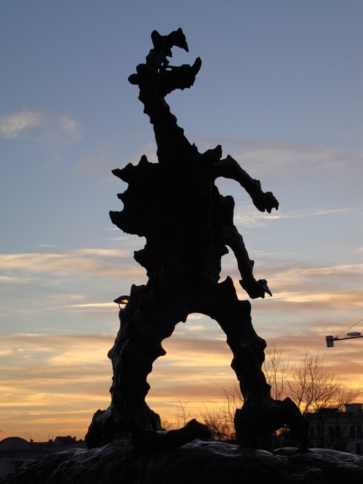 sculpture of the wawel dragon in krakow at dusk