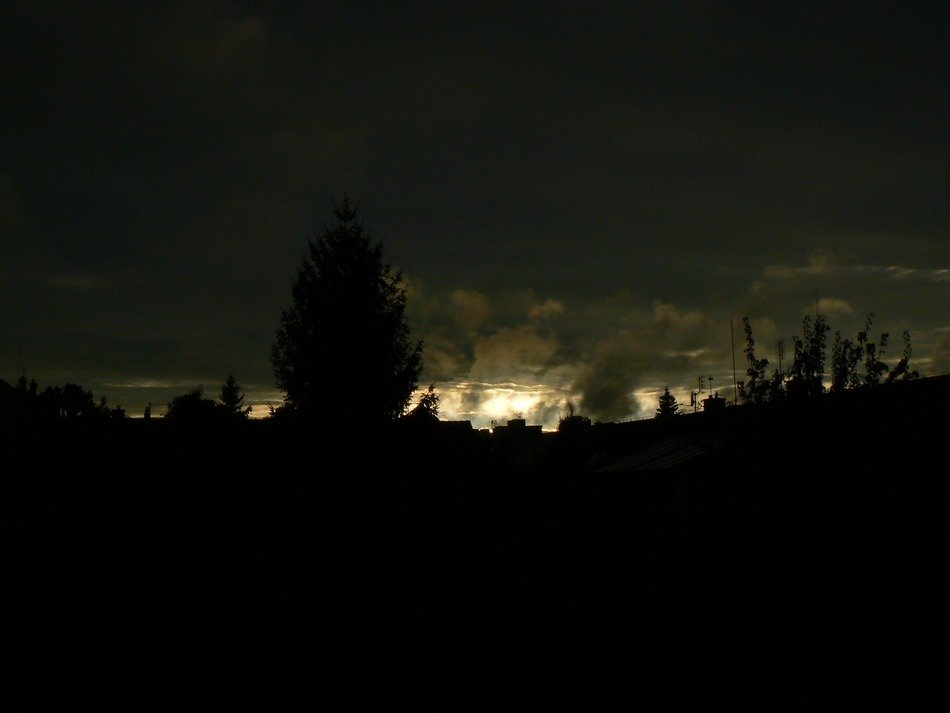 light on the horizon behind dark clouds